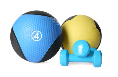 Photo of Medicine balls and dumbbells on white background