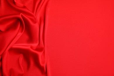 Texture of delicate red silk as background, top view