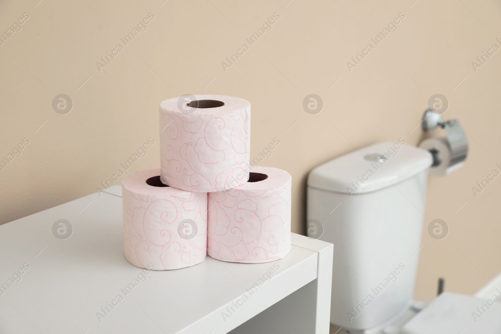 Photo of Toilet paper rolls on cabinet in bathroom