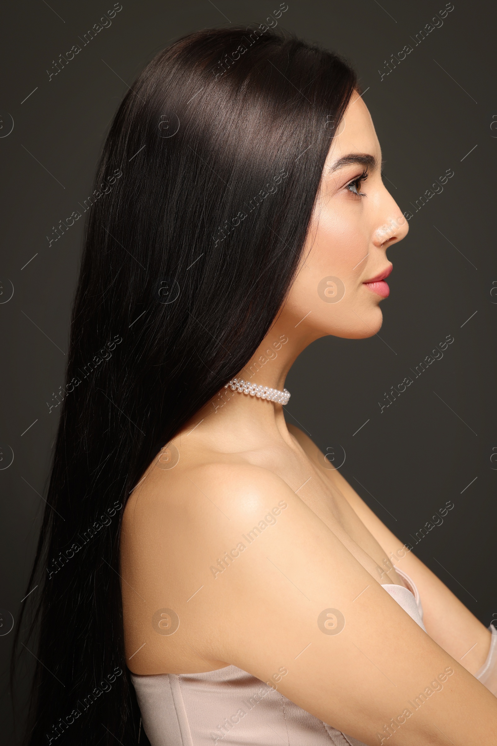 Photo of Young woman with beautiful makeup on black background