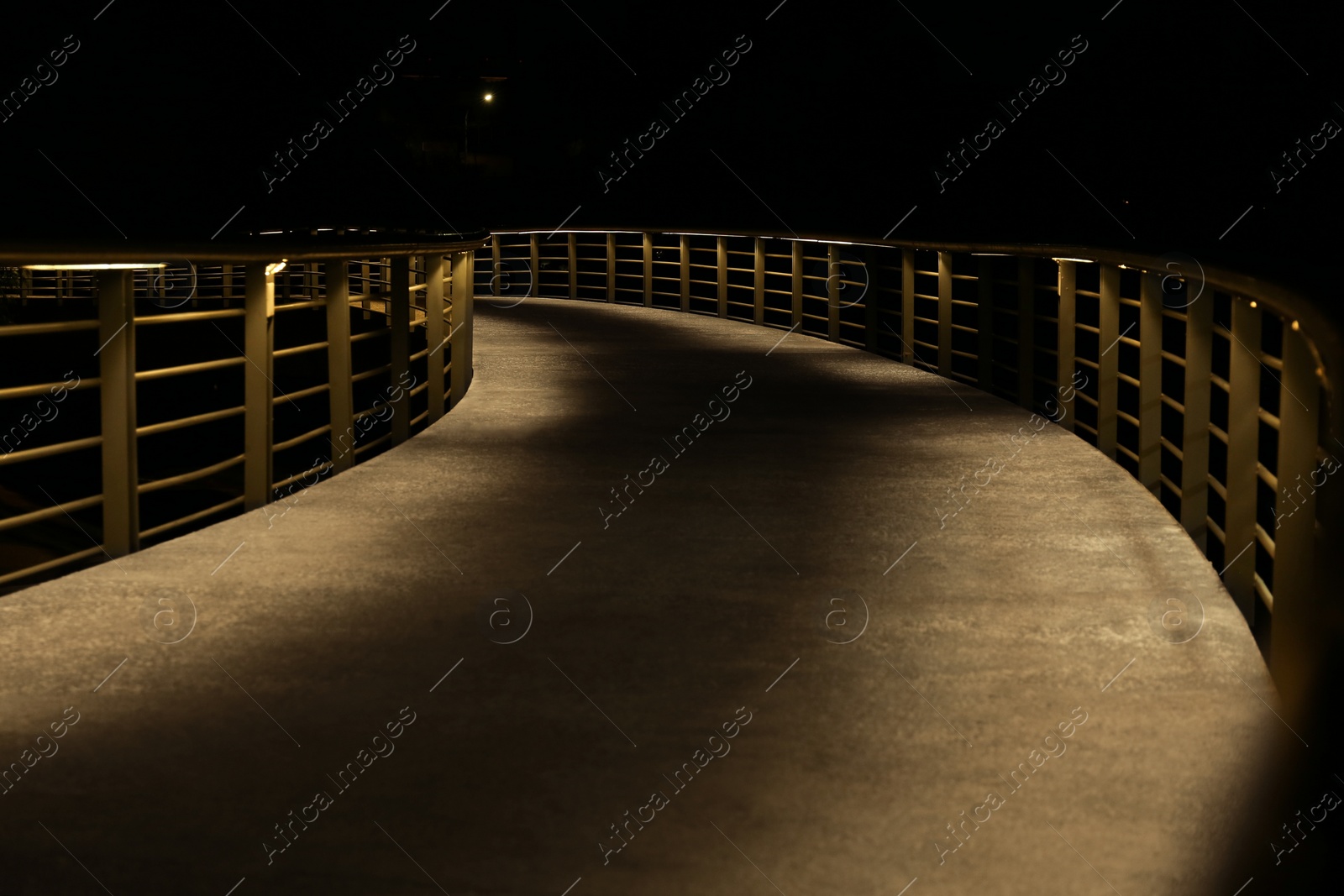 Photo of View of modern bridge in city at night