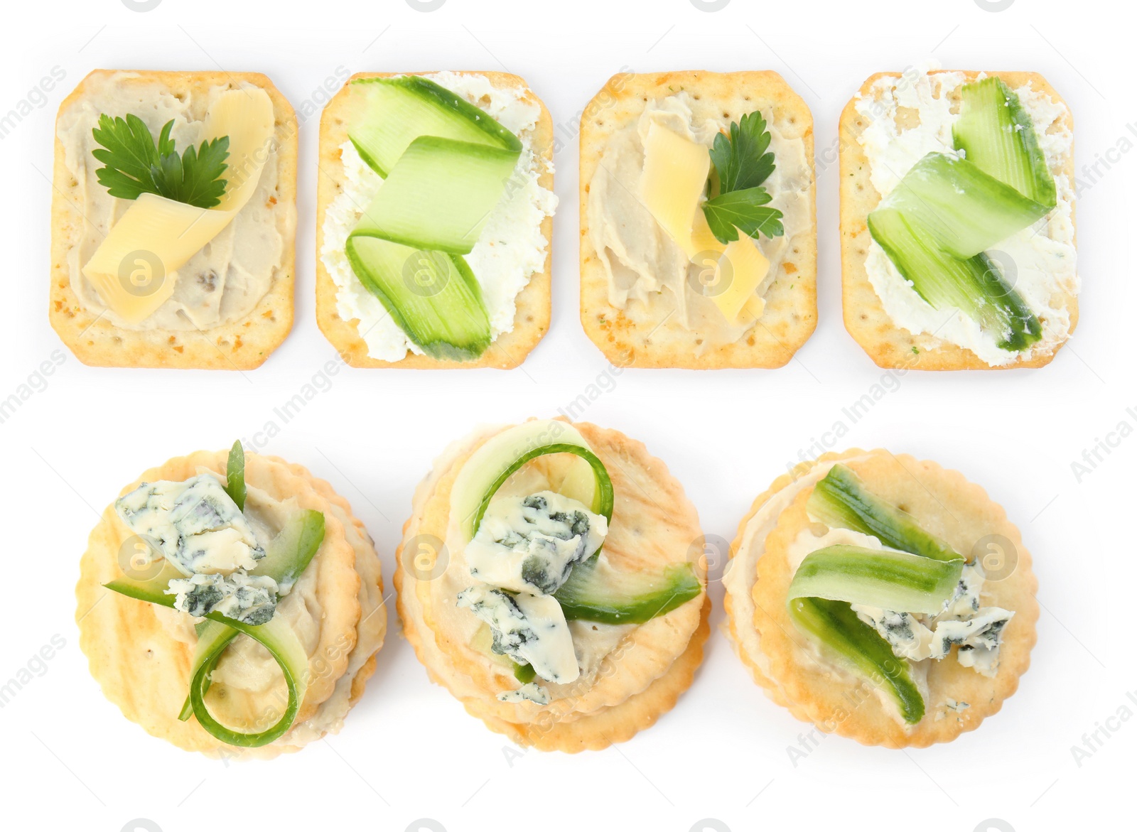 Image of Delicious crackers with different toppings isolated on white, top view