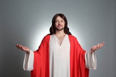 Photo of Jesus Christ with outstretched arms on light grey background