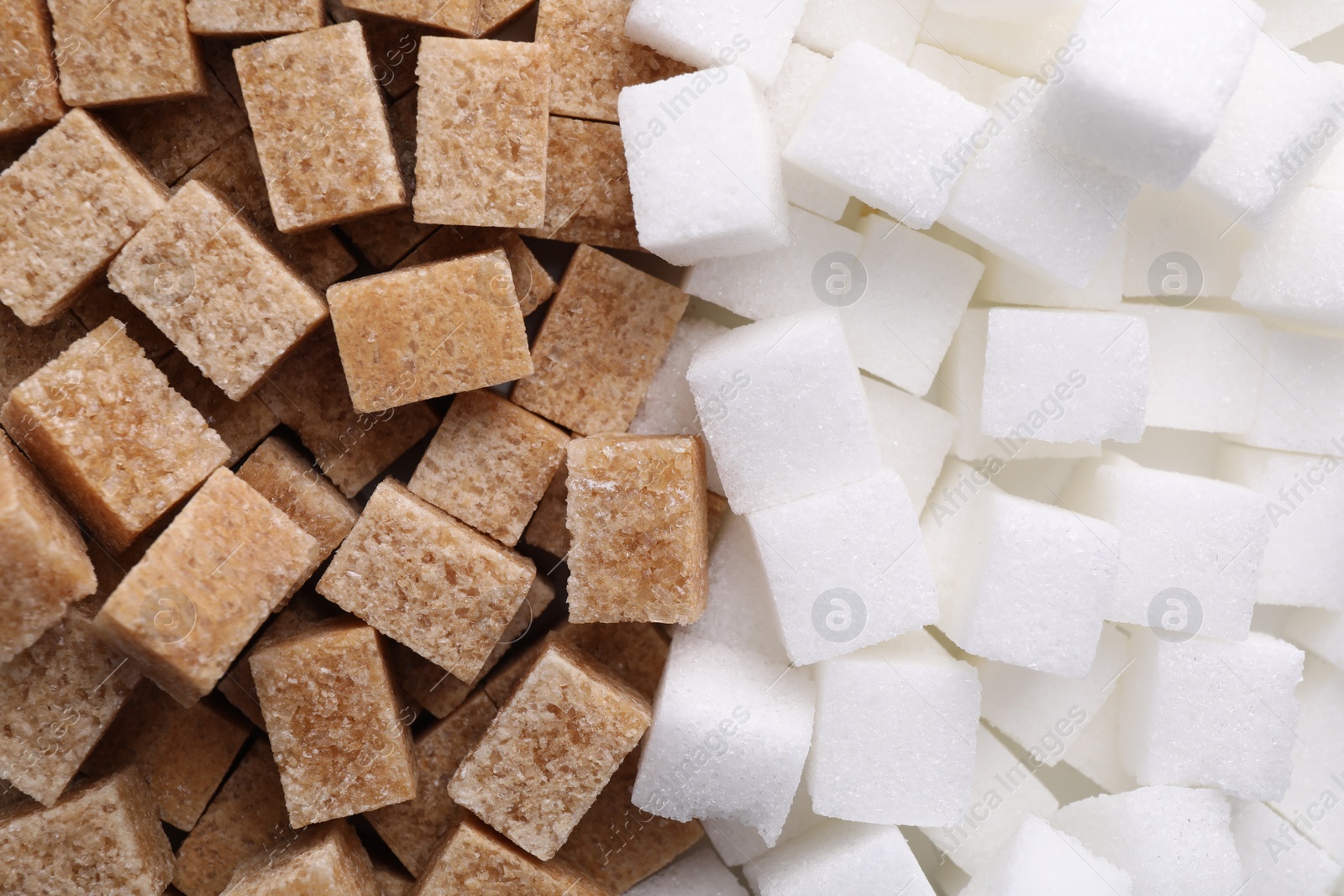 Photo of White and brown sugar cubes as background, top view