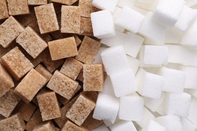 White and brown sugar cubes as background, top view