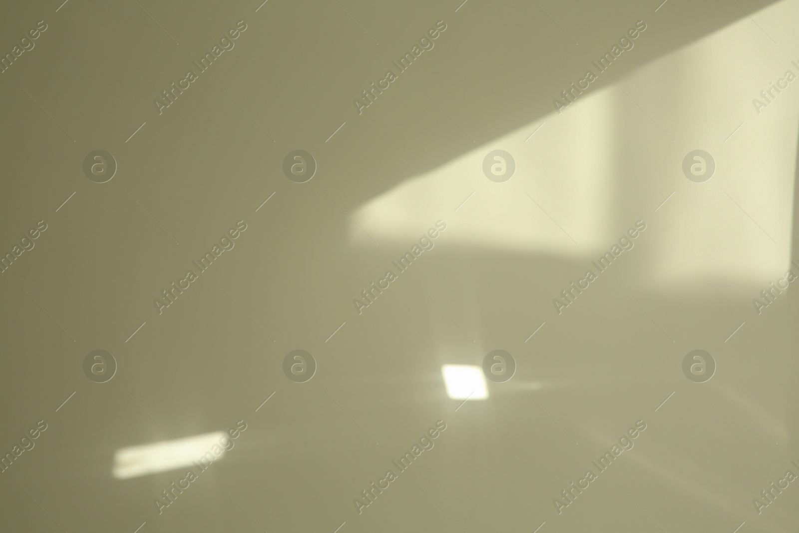 Photo of Light and shadow from window on beige wall indoors