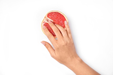 Photo of Young woman touching half of grapefruit on white background, top view. Sex concept