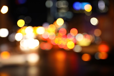 Photo of Blurred view of night city street with bokeh effect