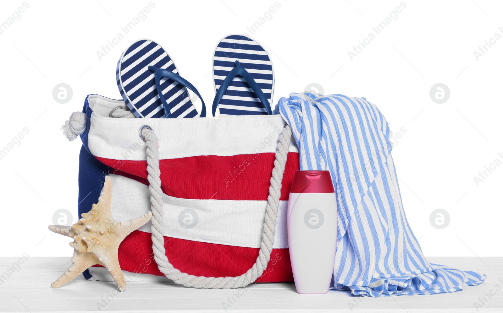 Photo of Stylish bag, starfish and other beach accessories isolated on white