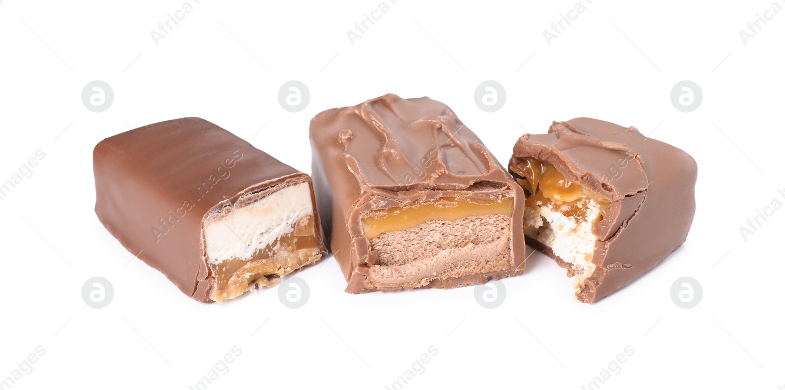 Photo of Pieces of tasty chocolate bars with nougat on white background