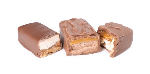 Photo of Pieces of tasty chocolate bars with nougat on white background