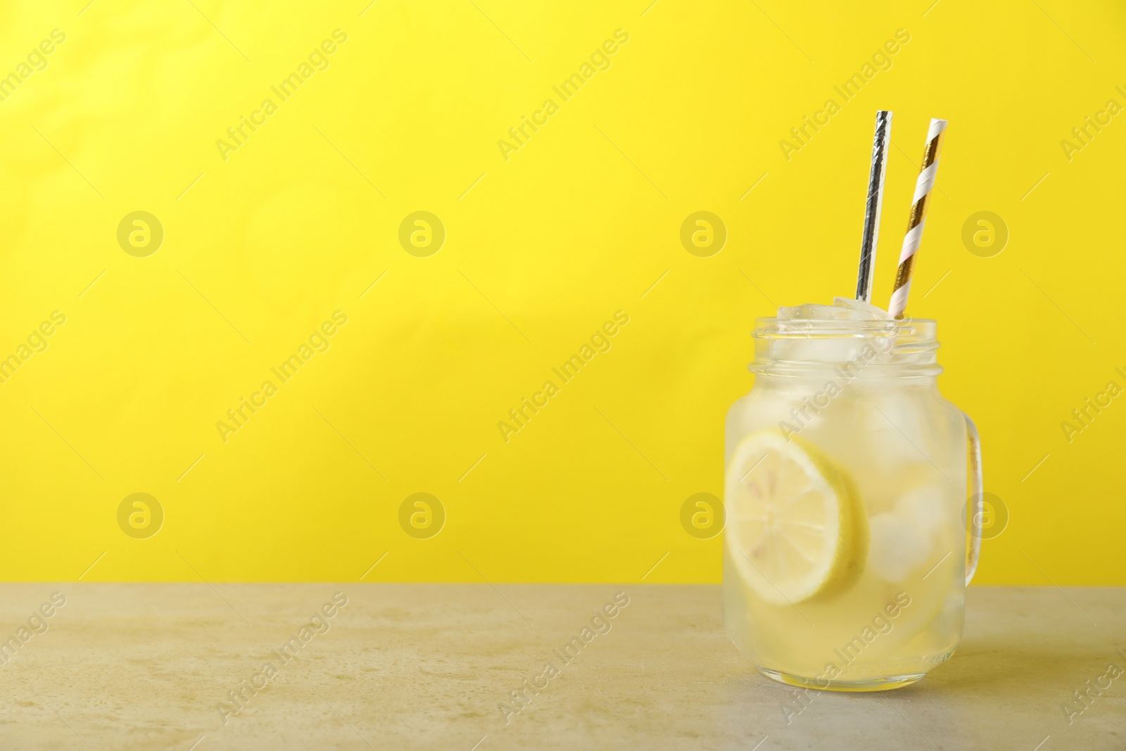 Photo of Natural lemonade on light grey table, space for text. Summer refreshing drink