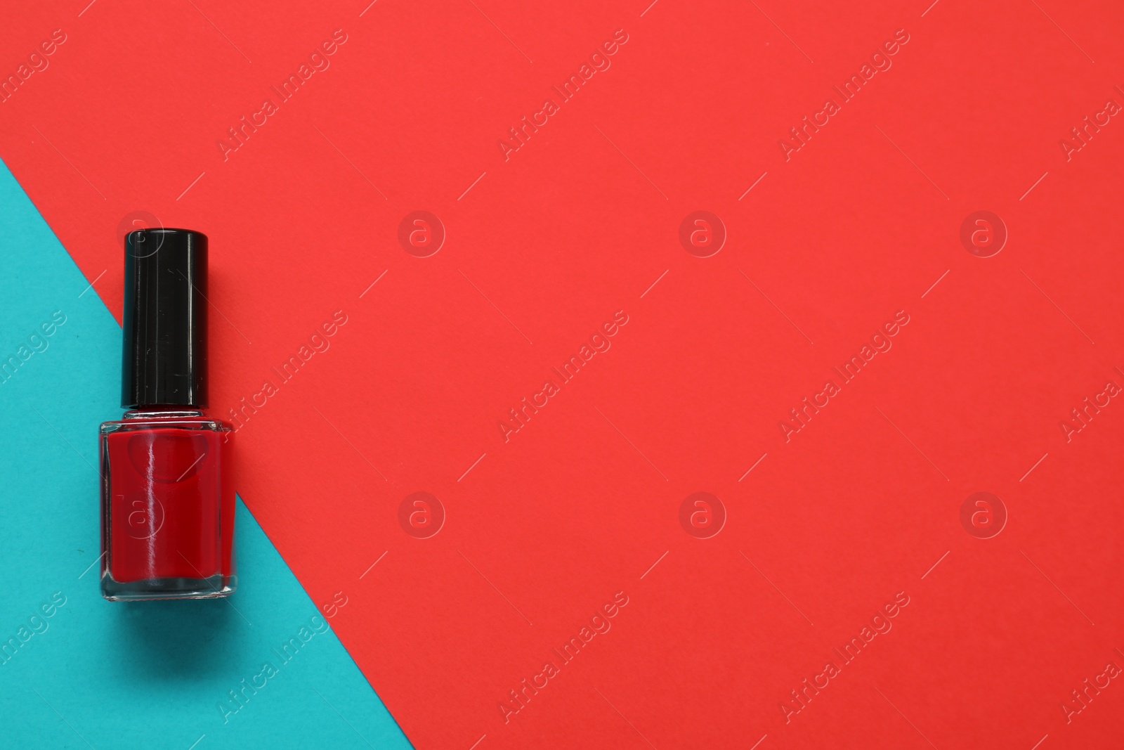 Photo of Nail polish on color background, top view. Space for text