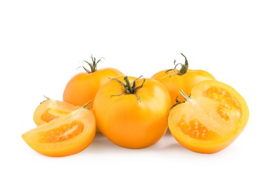 Photo of Cut and whole yellow tomatoes on white background