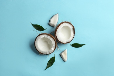 Flat lay composition with coconuts on color background