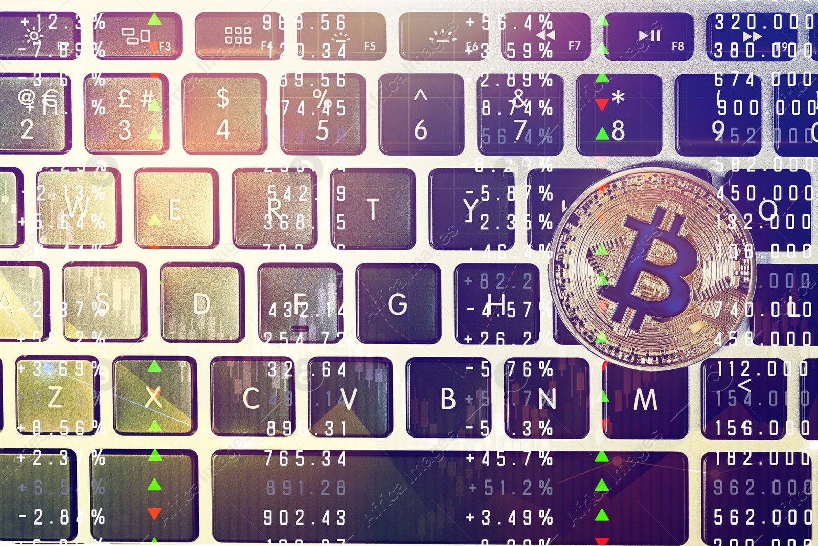 Image of Golden bitcoin on computer keyboard, top view
