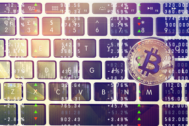 Image of Golden bitcoin on computer keyboard, top view
