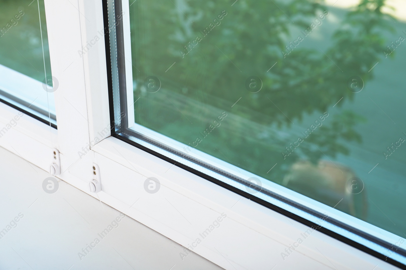 Photo of Modern glazed window and sill indoors, closeup