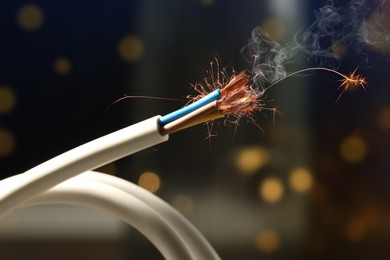 Image of Sparking wiring on blurred background, closeup view
