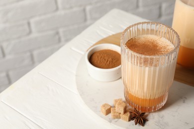 Delicious eggnog with anise and sugar on white wooden table. Space for text