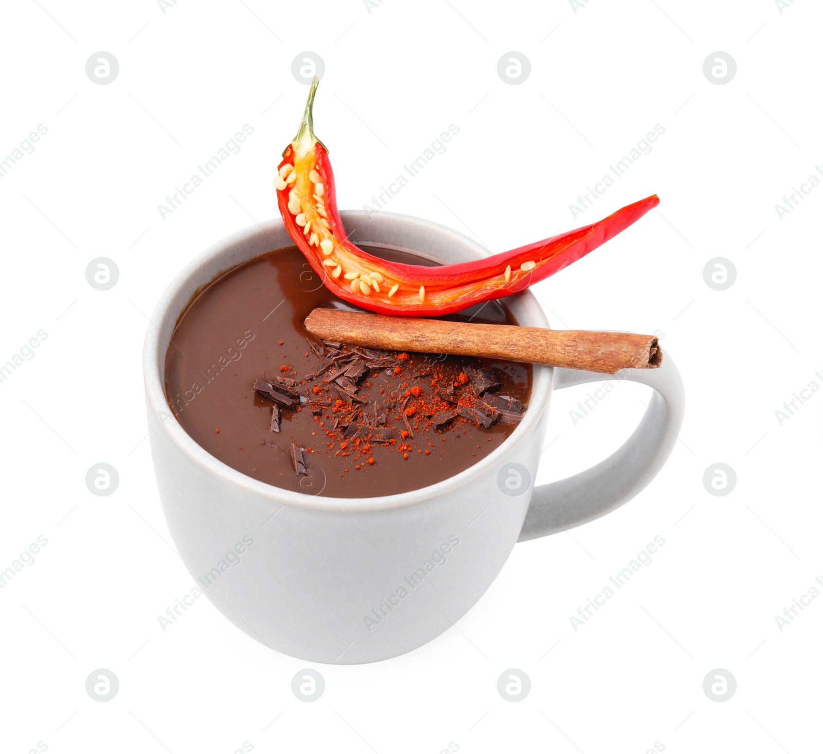Photo of Cup of hot chocolate with chili pepper and cinnamon on white background