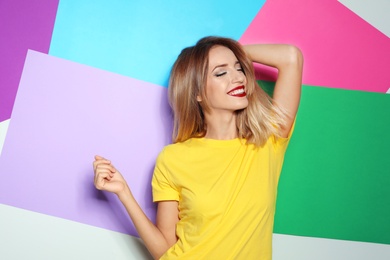 Photo of Beautiful young woman with healthy long blonde hair on color background