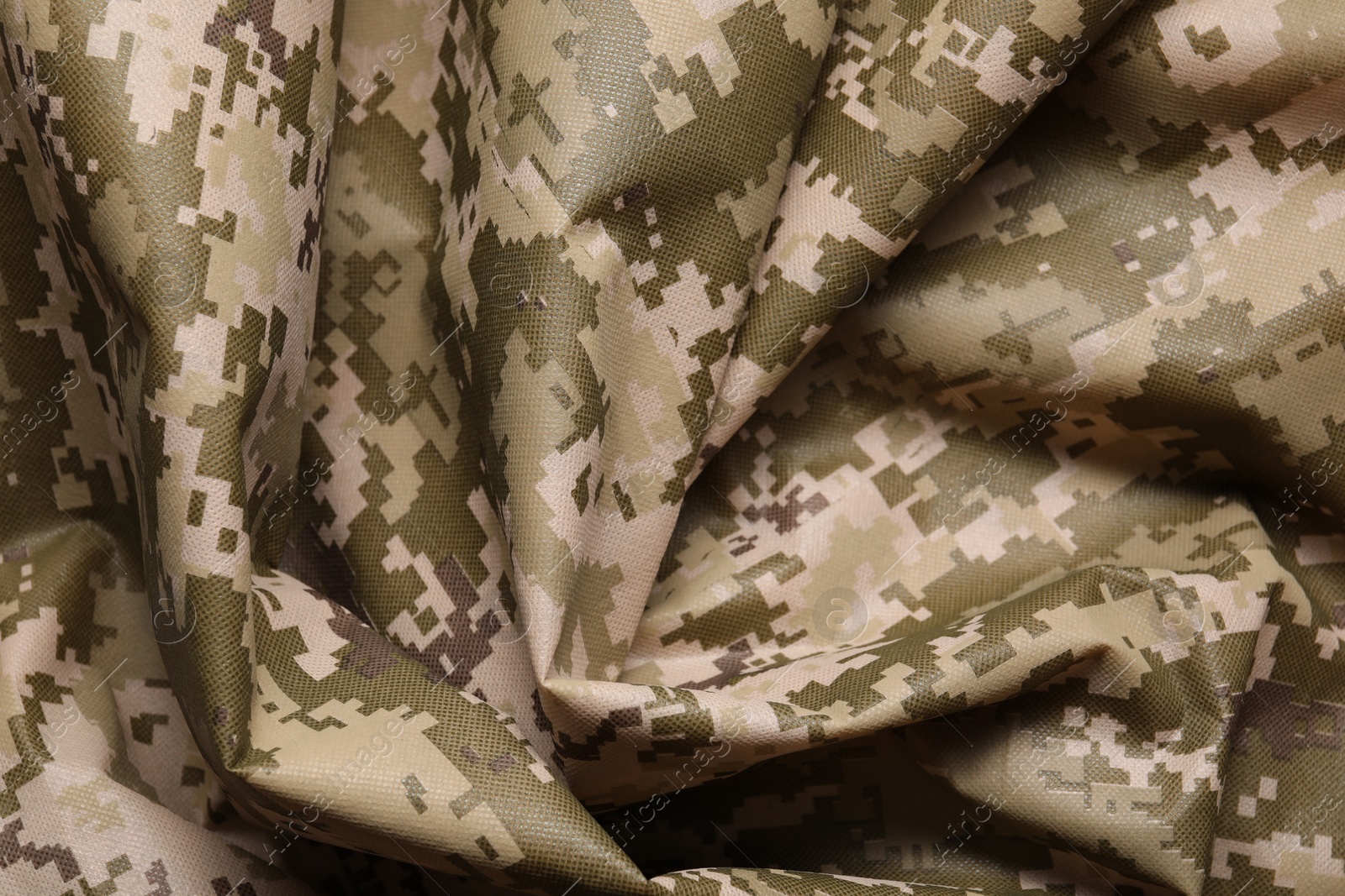 Photo of Texture of crumpled camouflage fabric as background, top view