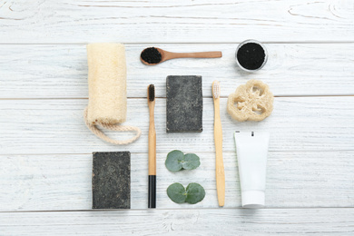 Photo of Flat lay composition with bamboo toothbrushes on white wooden table