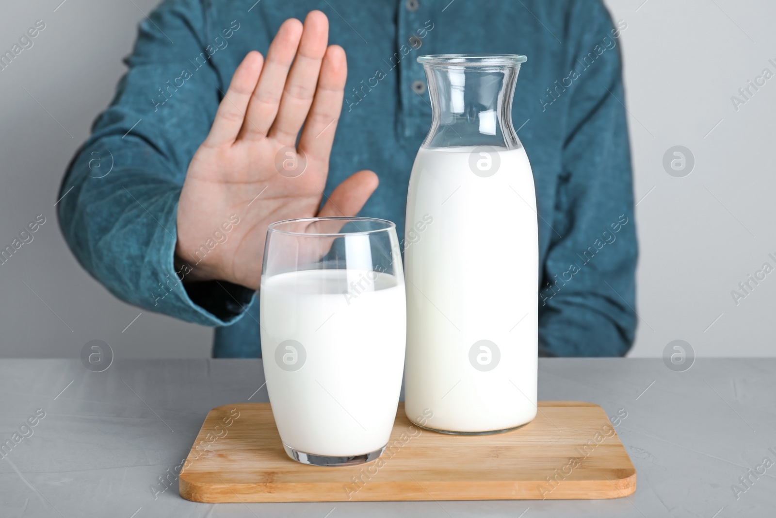 Photo of Man refusing to drink milk, closeup. Food allergy concept