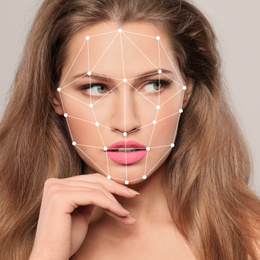 Image of Facial recognition system. Woman with digital biometric grid on light background