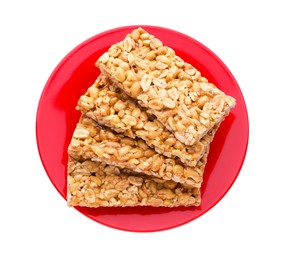 Photo of Plate with tasty peanut bars (kozinaki) isolated on white, top view