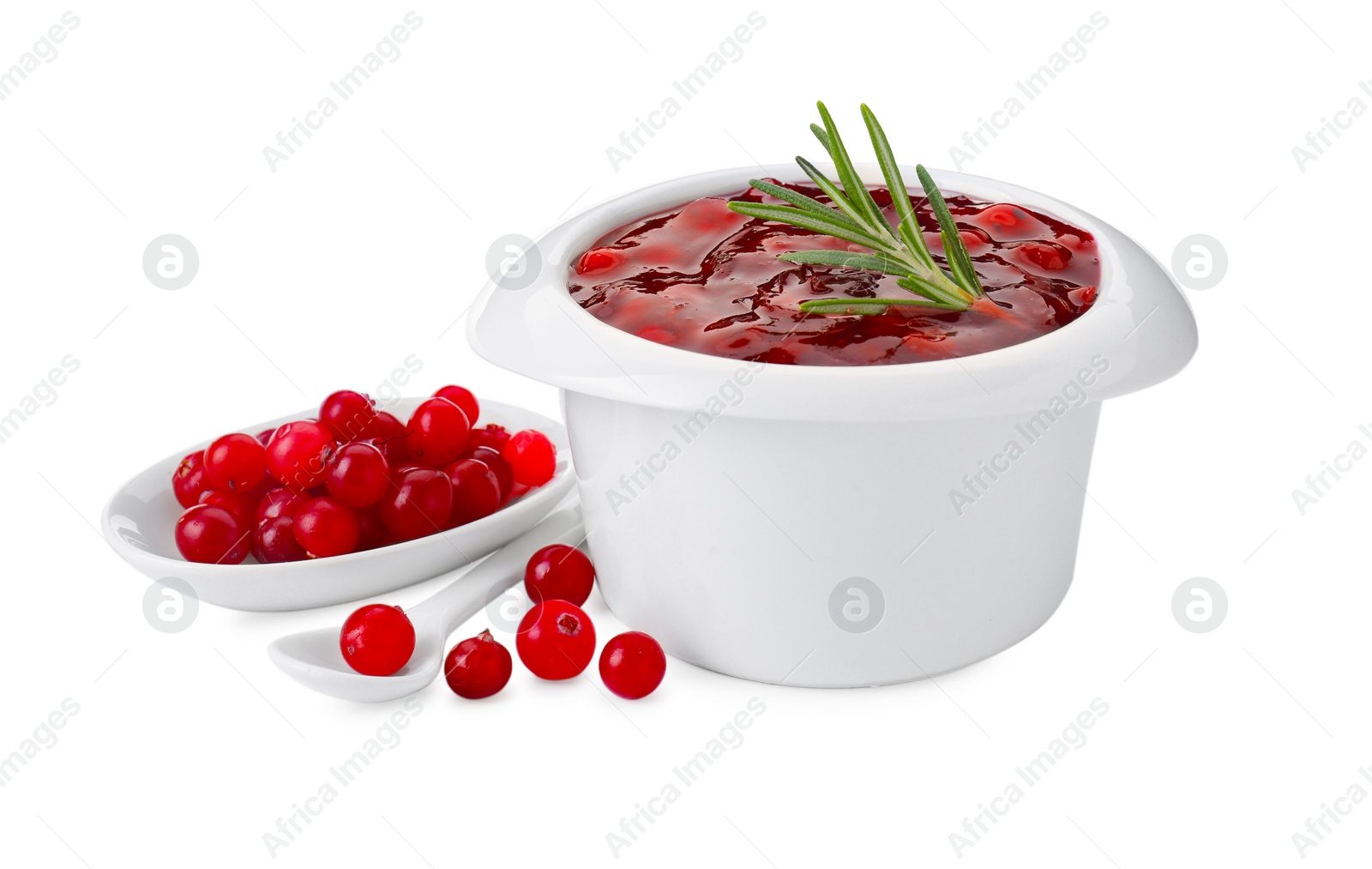 Photo of Cranberry sauce in bowl, fresh berries, spoon and rosemary isolated on white