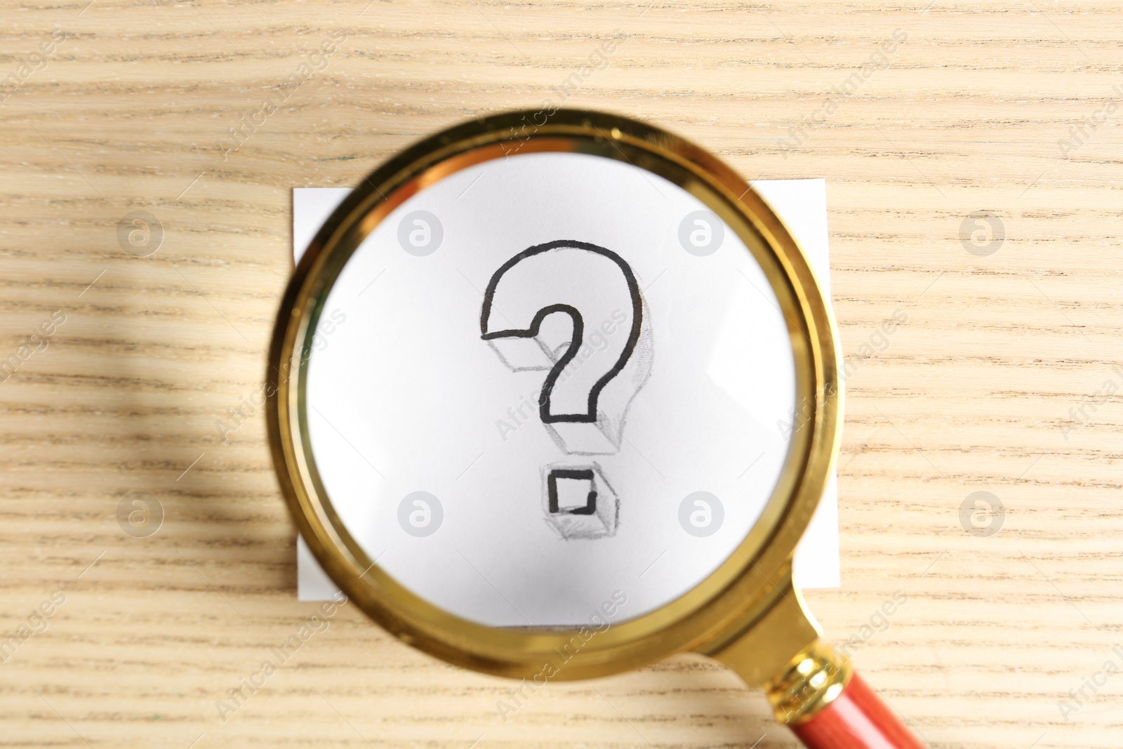 Photo of Magnifying glass over card with question mark on wooden background, top view. Search concept