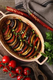 Delicious ratatouille and ingredients on table, flat lay