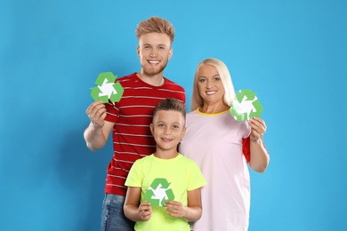 Family with recycling symbols on blue background