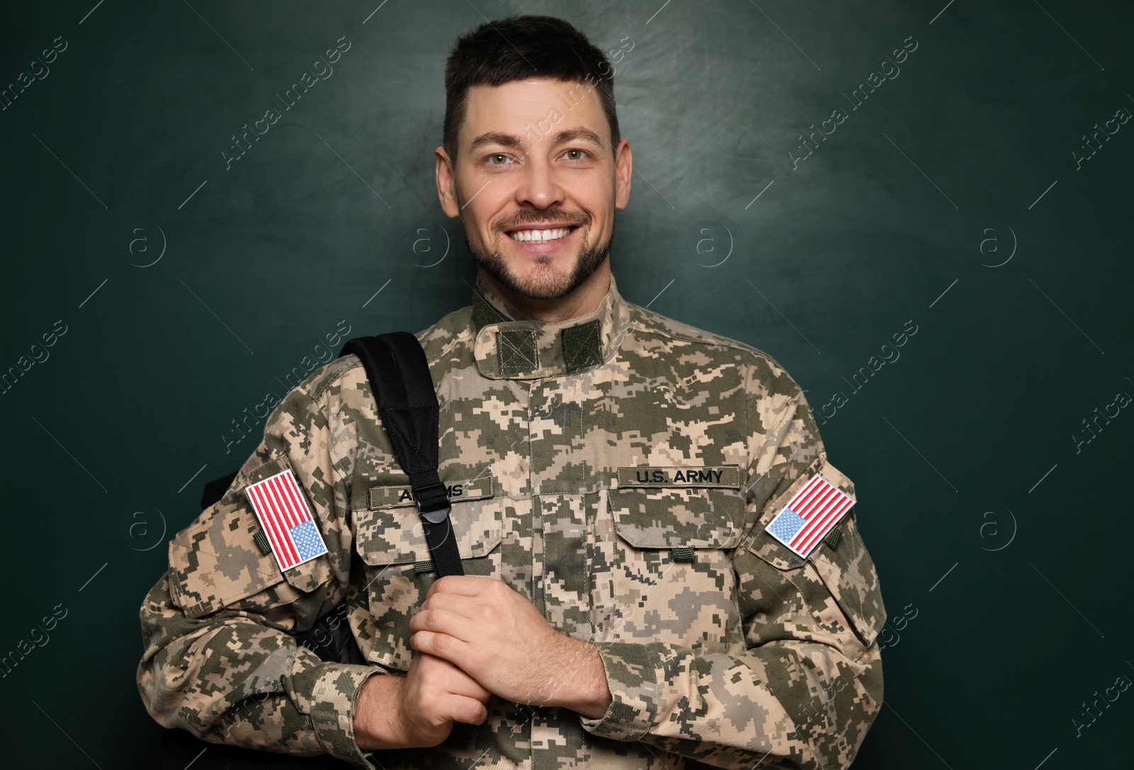 Photo of Cadet with backpack near chalkboard. Military education