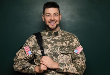 Photo of Cadet with backpack near chalkboard. Military education