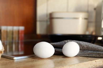 Fresh eggs on wooden table in kitchen. Ingredient for breakfast
