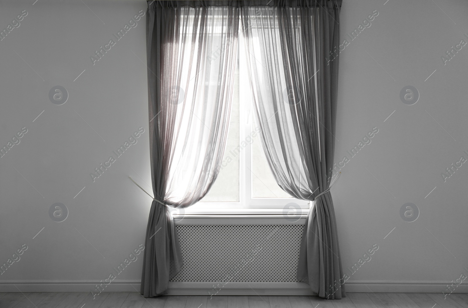 Photo of Window with beautiful curtains in empty room