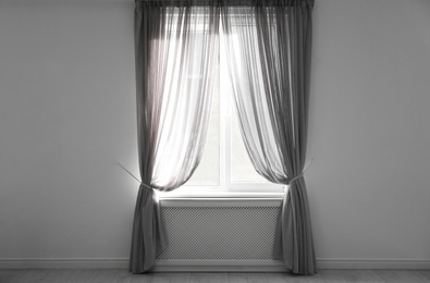 Window with beautiful curtains in empty room