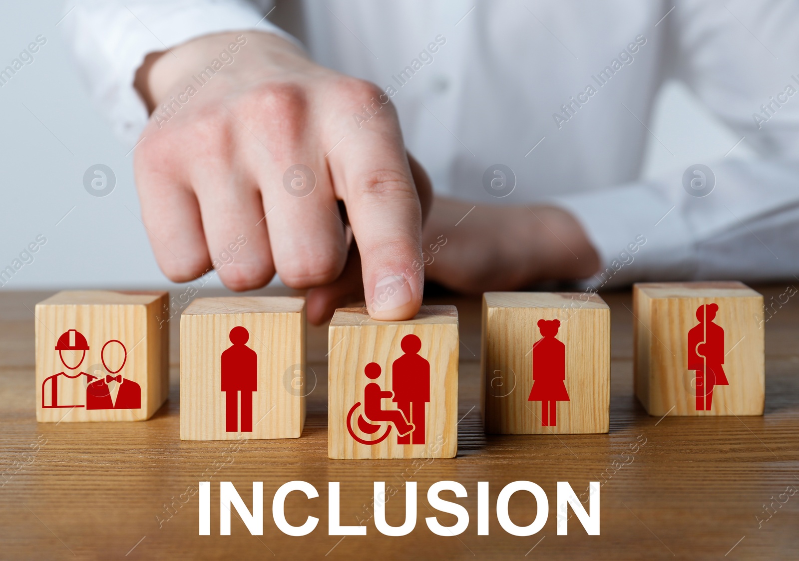 Image of Concept of DEI - Diversity, Equality, Inclusion. Businessman and wooden cubes with images of people on table, closeup