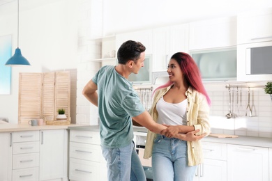 Photo of Beautiful couple dancing in kitchen at home
