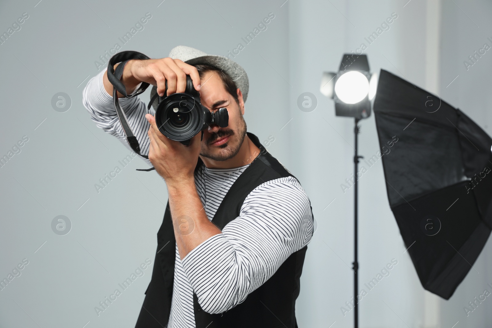 Photo of Professional photographer taking picture in modern studio