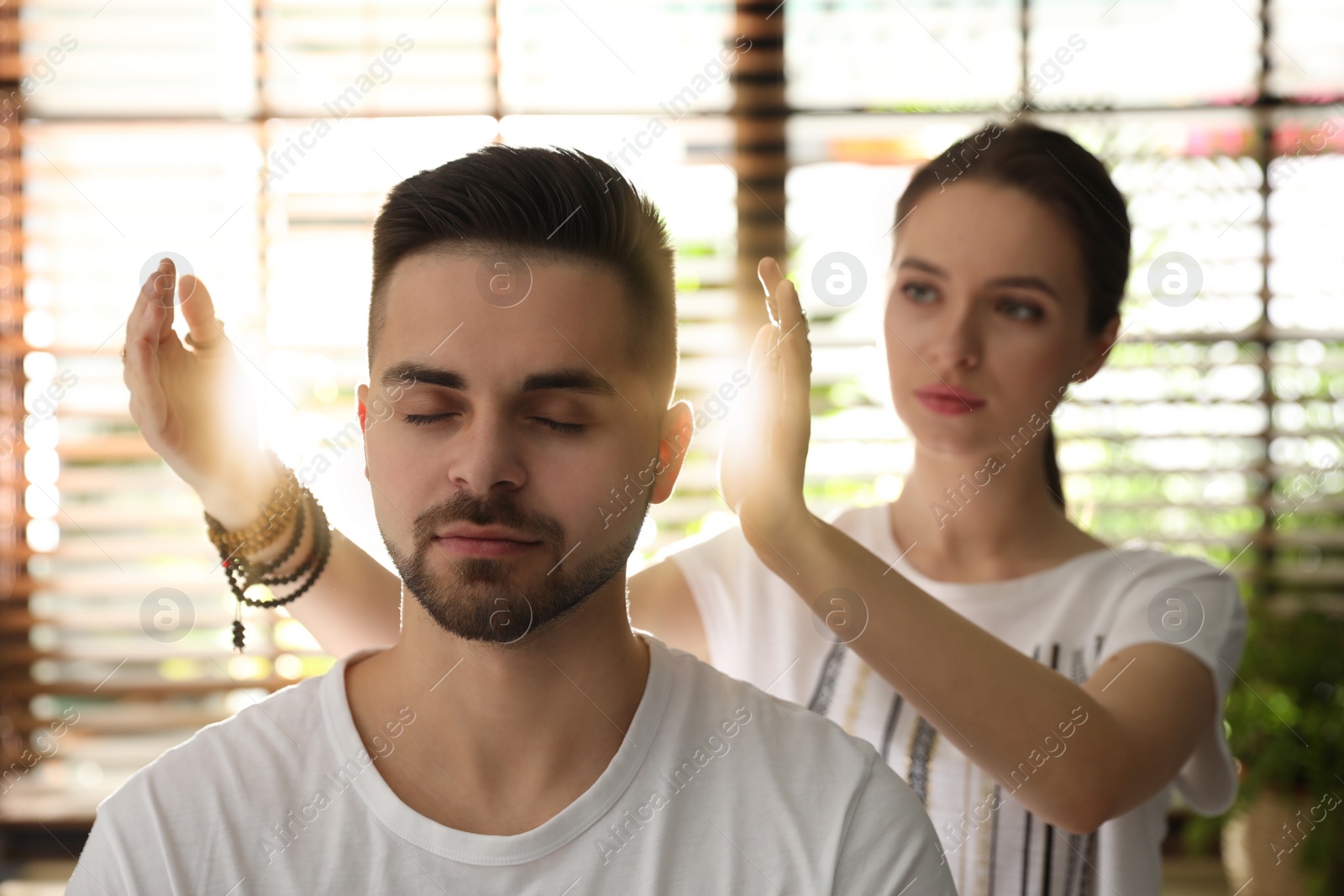 Photo of Young man during healing session in therapy room