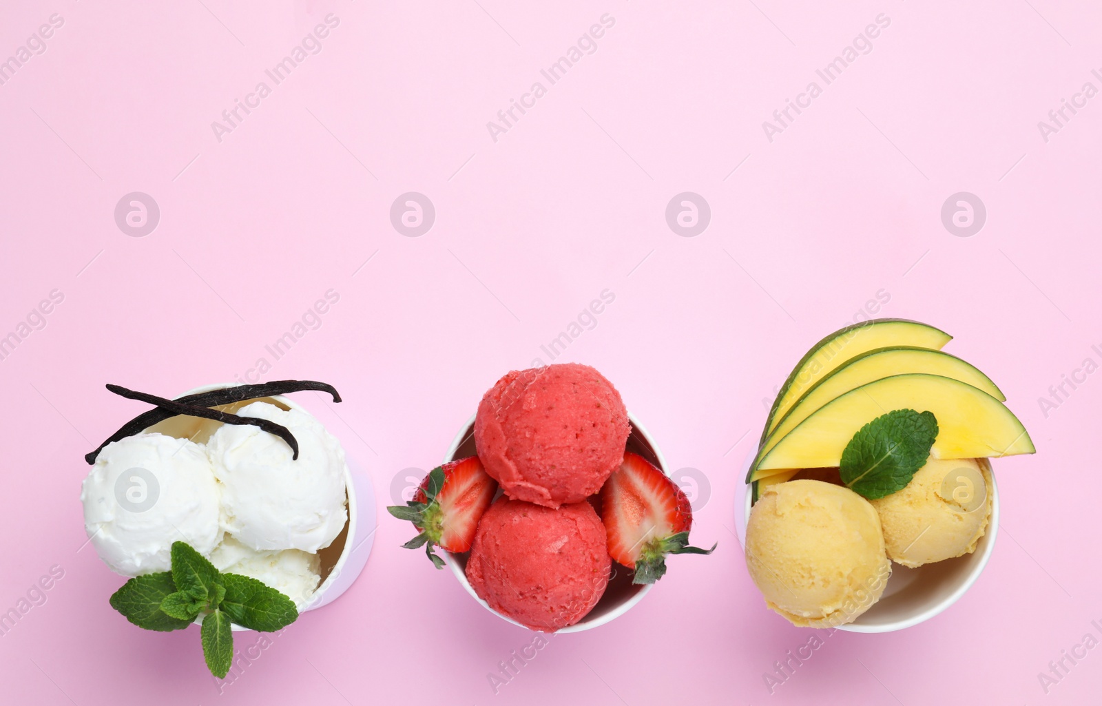 Photo of Different delicious ice creams on pink background, flat lay. Space for text