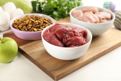 Natural pet food on white wooden table, closeup