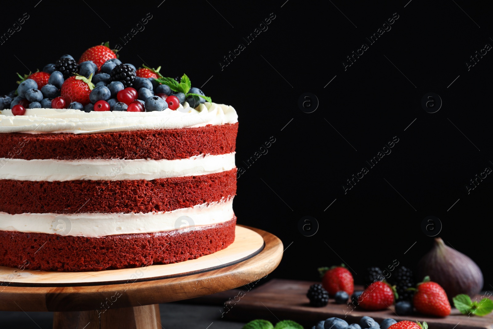 Photo of Composition with delicious homemade red velvet cake and space for text on black background