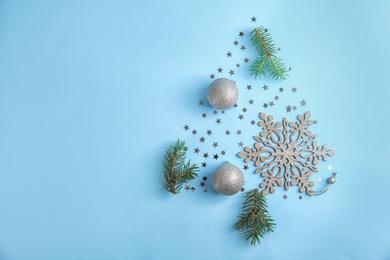 Flat lay composition with branches of Christmas tree on color background