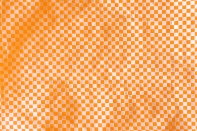 Texture of orange and white checkered fabric as background, top view