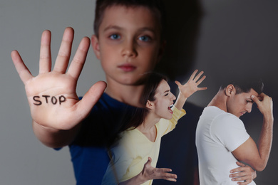 Image of Double exposure of sad little boy showing palm with word STOP and his arguing parents